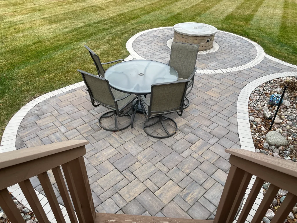 IMG_1605 Outdoor stone patio with a firepit.