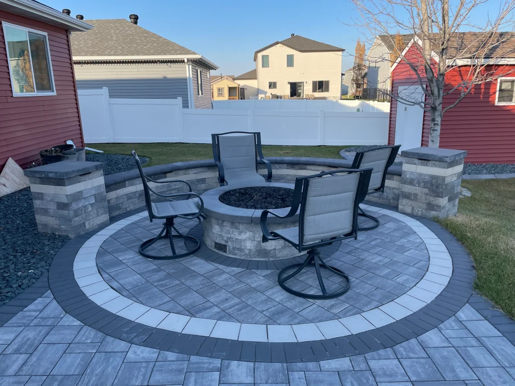 IMG_1638 Outdoor stone patio with columns, ledge, firepit.