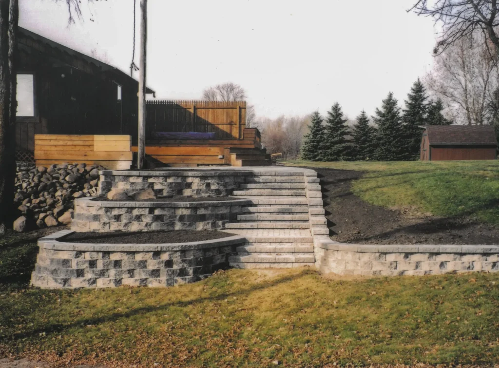 SKM_C451i24121707500 Stone stairs with ledge and elevated dirt sections.