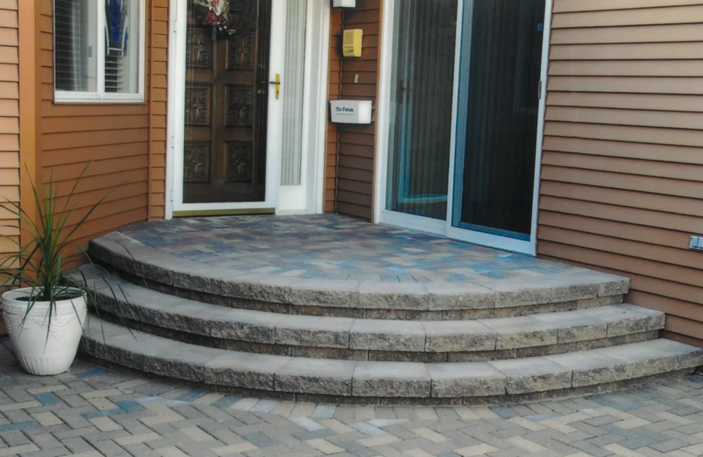 SKM_C451i24121707510 Brick patio with stone steps.
