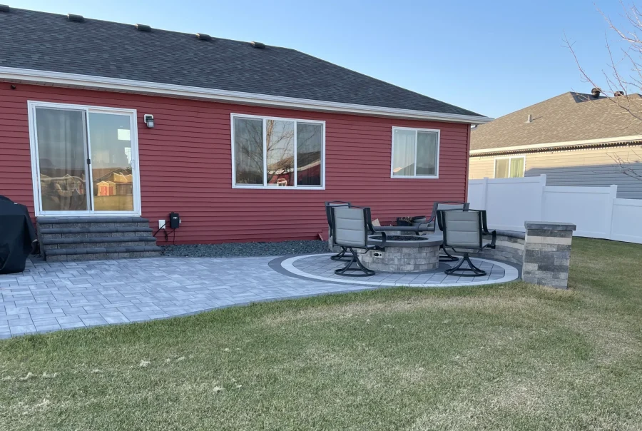 Brick patio with firepit, ledge, and column.