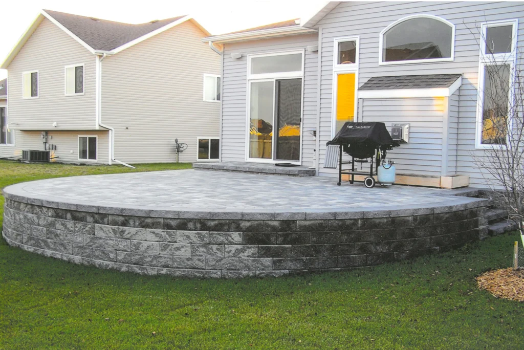 SKM_C451i24121715540_EDIT Elevated stone backyard patio.