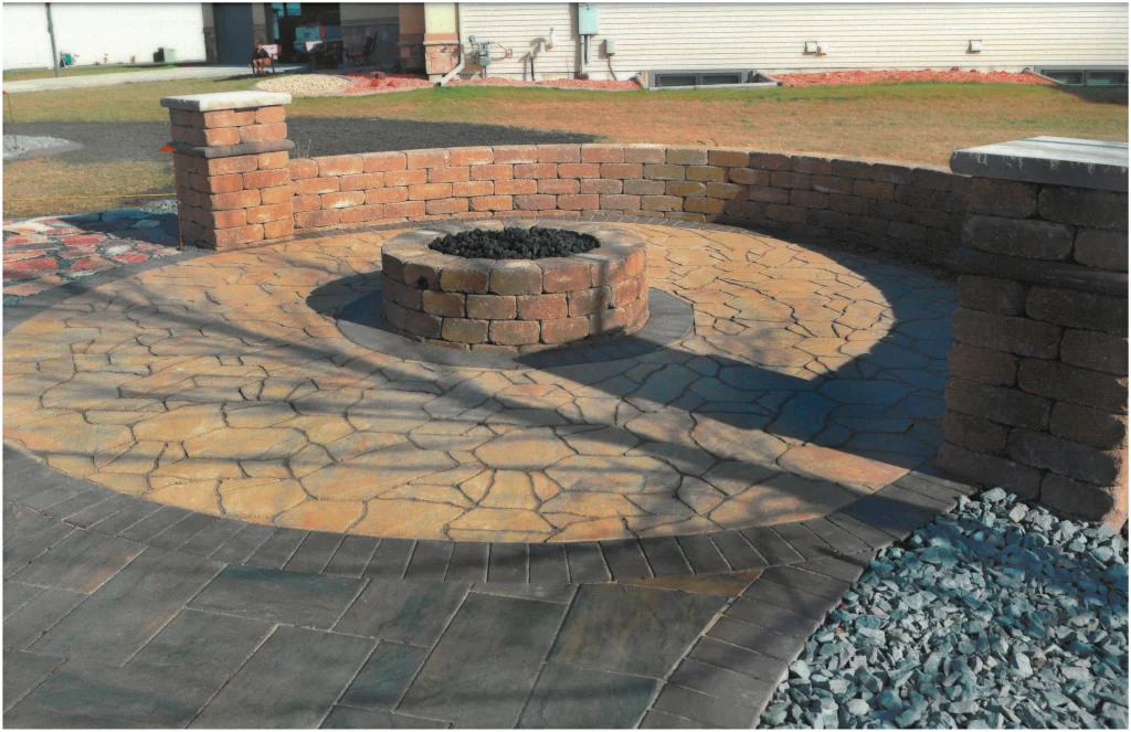 SKM_C451i24121716140 Stone patio with brick fireplace, brick columns, brick ledge.
