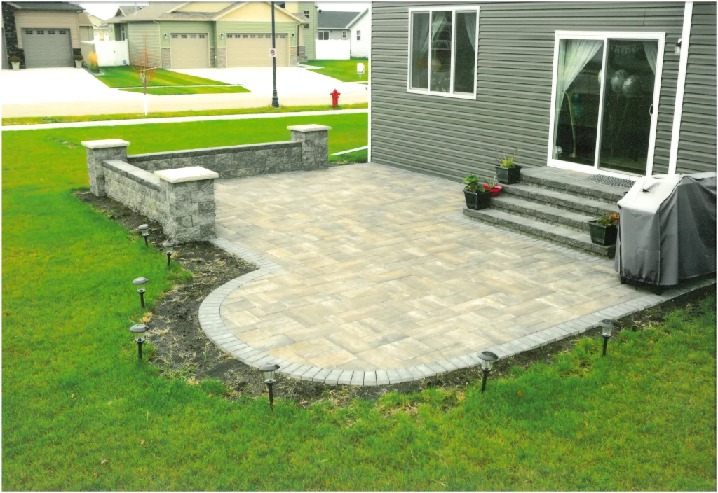 SKM_C451i24121716230_EDIT Stone backyard patio with stone columns and ledges.