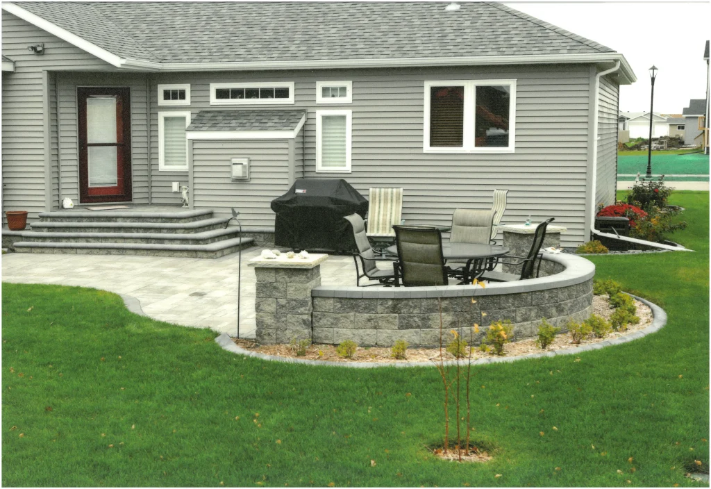 SKM_C451i24121716340_EDIT Stone patio with stone columns and ledge.