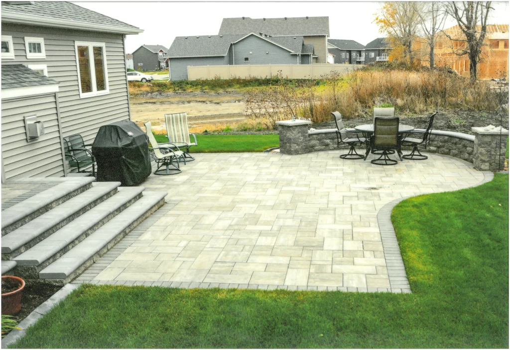 SKM_C451i24121716370_EDIT Stone backyard patio with stone columns and ledge.