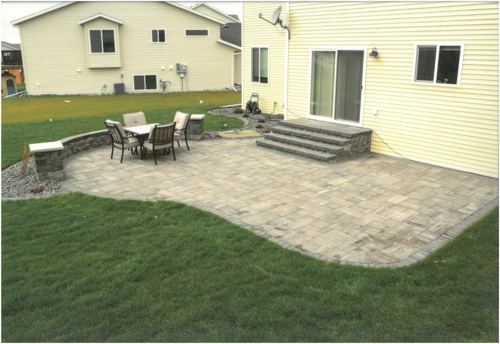 SKM_C451i24121716430_EDIT Backyard stone patio with columns and ledge.